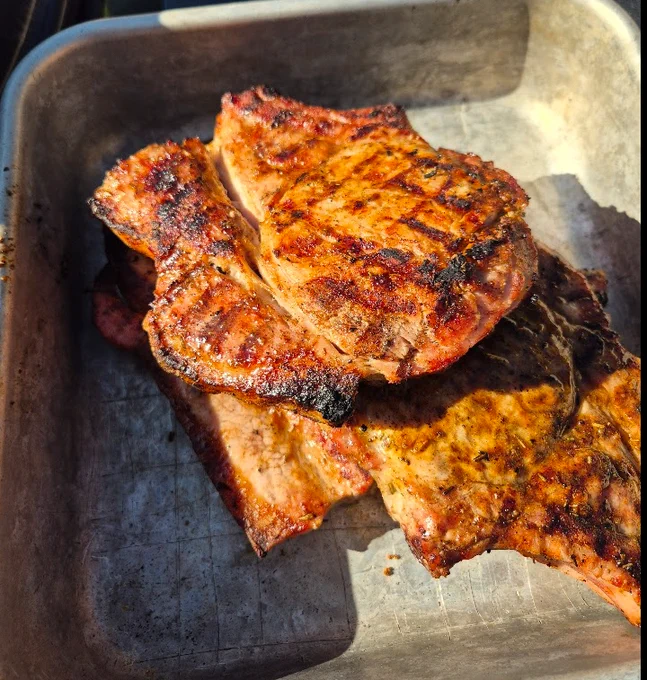 Dry rub grilled pork loin chops in a pan. 
