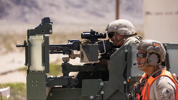 Marines operate a mounted machine gun from a tactical vehicle while observing targets during training.