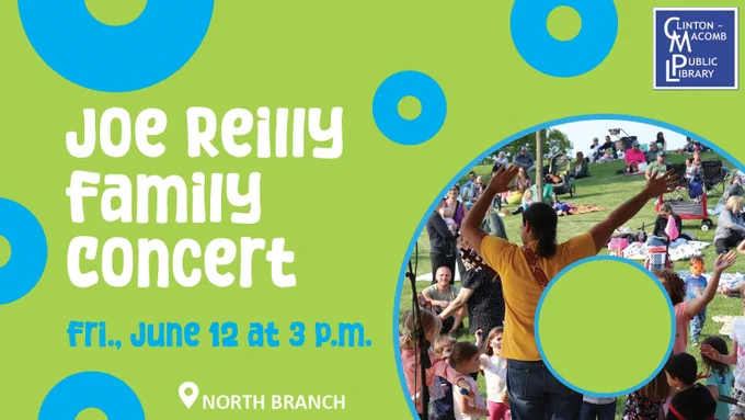 Families gathered on a grassy hill for Joe Reilly's concert, with children and adults watching the show outdoors.