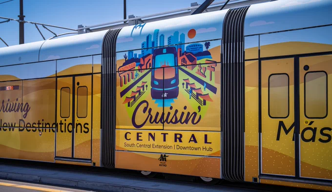 A light rail train car wrapped with art that says "Cruisin' Central."