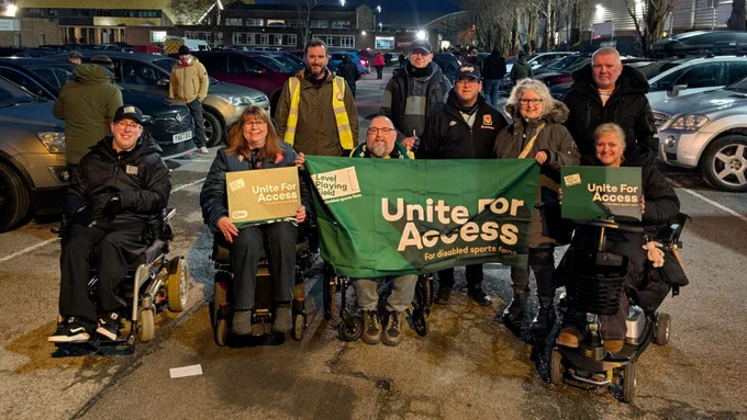 Members of the disabled supporters' associations at Wrexham and Swansea, together with Level Playing Field and Wrexham staff, holding green 'Unite For Access' boards and a banner.