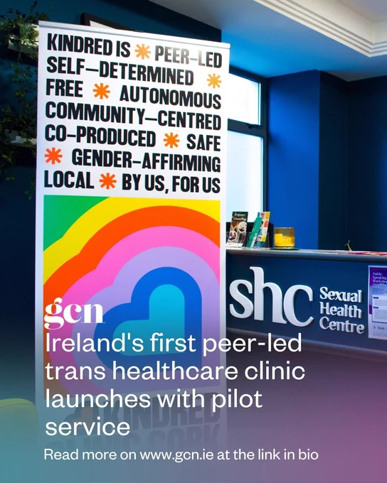 The hall of Sexual Health Centre Cork with a banner about Kindred Clinic, Ireland's first peer-led trans healthcare pilot service. It has a blue and purple gradient with the GCN logo and the article's title that reads: "Ireland's first peer-led trans healthcare clinic launches with pilot service". At the bottom of the image, a message says: "Read more on www.gcn.ie at the link in bio".