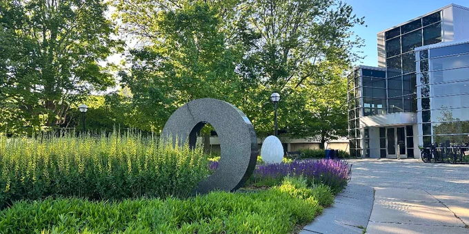 University of Michigan North Campus Research Complex Building 18 entrance with flowers June 2026