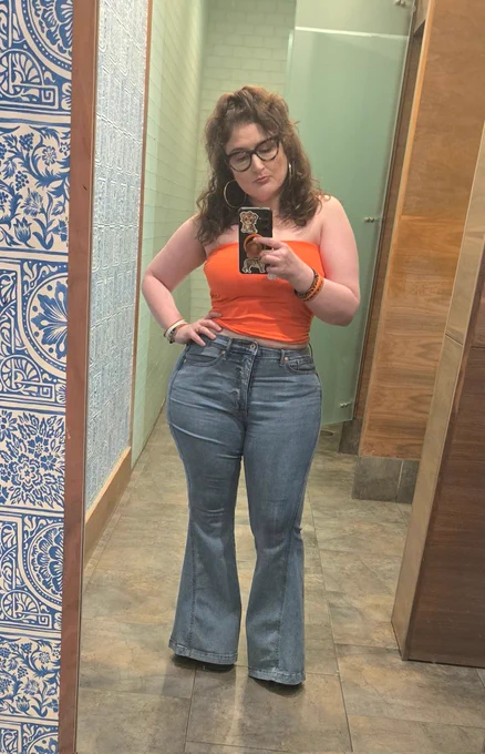 I'm standing in a mirror with an orange tube top and bell bottom jeans. Got my hair down and curly, hoop earrings and tiger framed glasses. Finest bitch you'll ever see. If you reading this I miss you 