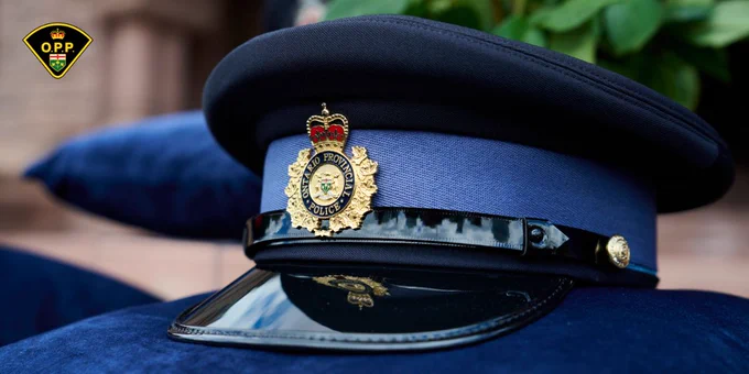 Ontario Provincial Police cap sits on top of a blue velvet pillow