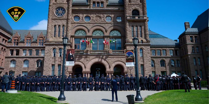 Uniformed police officers gather shoulder to shoulder at the Ontario Police Suicide Memorial in Toronto