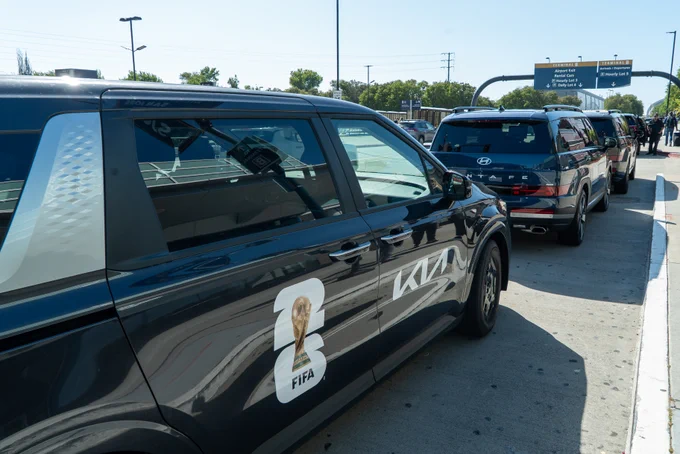 Official soccer tournament vehicles line up outside of the airport in San José.
