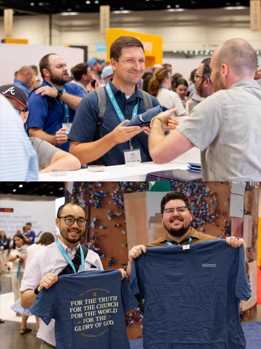 People engaging at a conference booth, receiving and showcasing branded T-shirts. Smiling attendees add a lively atmosphere to the event.