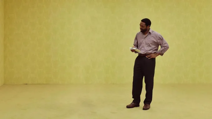 Chiwetel Ejiofor looking at an empty part of the Backrooms set.