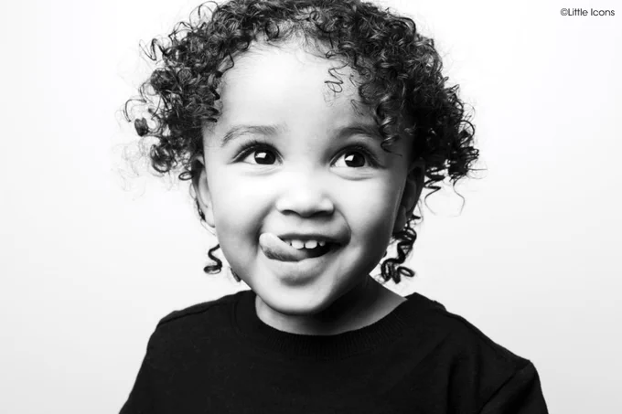 A little boy smiling. Copyright Little Icons.
