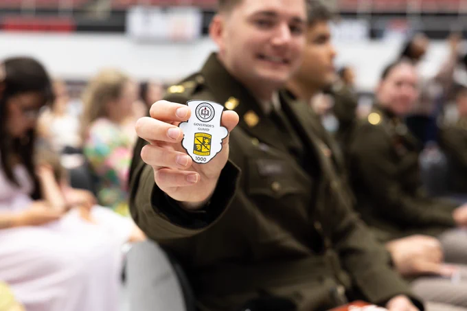 ROTC cadet showing a coin