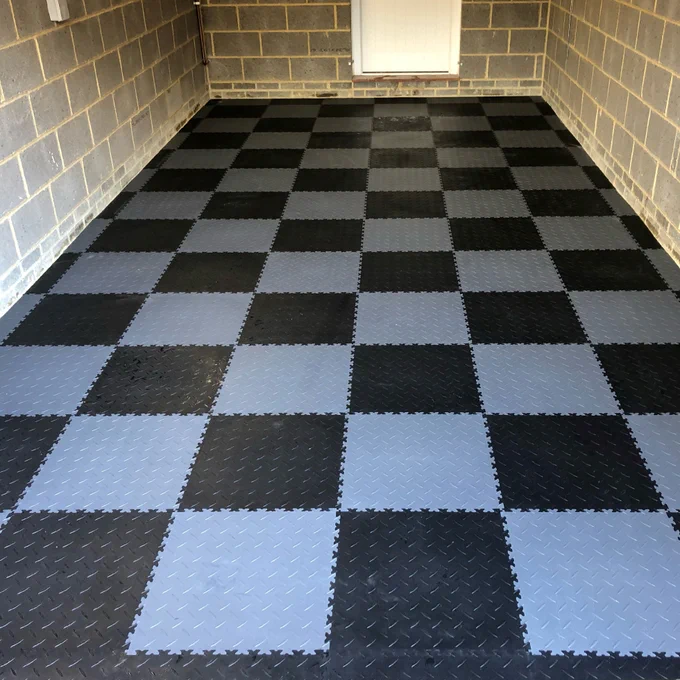 These Black Recycled Diamond Plate - MotoLock Interlocking Floor Tile can be laid quickly and easily on any reasonably smooth and level concrete base creating ready-for-use, dust-free, anti-skid surfaces and can be easily cleaned with a brush and sponge floor mop. The tiles simply snap together. No nails or glue are required, which means your floor can be easily transferred or reused again. Give your flooring a fresh and modern feel.