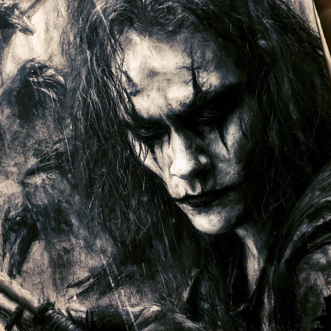 Eric Draven from The Crow, rendered entirely in traditional charcoal drawing style. Striking close-up portrait with long black hair framing his face, iconic black-and-white face paint, intense sorrowful eyes, and a haunting expression. Rain falls through the scene as ravens emerge from the shadows behind him. Rich charcoal textures, expressive hand-drawn strokes, deep monochrome shadows, brilliant highlights, visible fine art paper grain, masterful shading and smudging techniques, dramatic chiaroscuro lighting, black leather coat, gothic atmosphere, emotional intensity, traditional charcoal realism, museum-quality fine art, cinematic noir mood, highly detailed portrait, monochrome masterpiece, ultra-detailed, 8K.