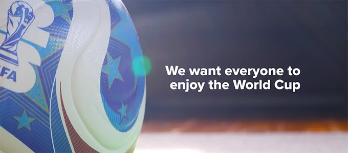 A FIFA World Cup football with the logo and blue star pattern, with text 'We want everyone to enjoy the World Cup'.