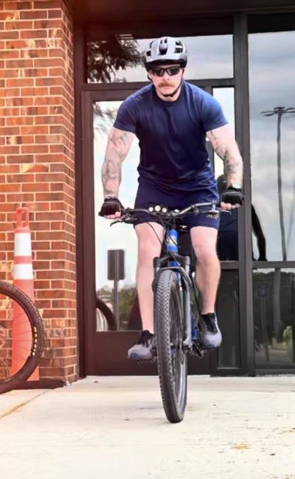Picture of a Michigan State Police officer riding his bicycle during a training exercise.