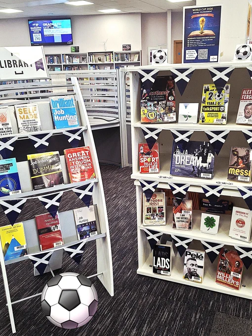 Football themed book display with Scotland flags.