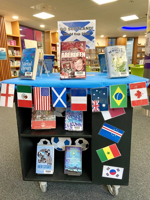 Football themed book display with the header Go Scotland! World Cup 2026 and bunting with the flags of countries taking part in the World Cup.