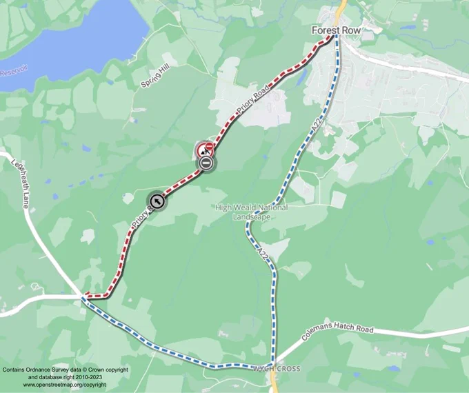 A map showing a route near Forest Row. The path is marked with a red line labeled "A22" and a dashed blue line. Notable roads include Priory Road and Colemans Hatch Road. The High Weald National Landscape is highlighted on the map.