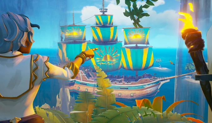 A pirate points out at a Galleon sporting resplendent sails of blue that feature yellow lines running up the edges of the sheets to frame a golden sun depicted peering over the horizon.