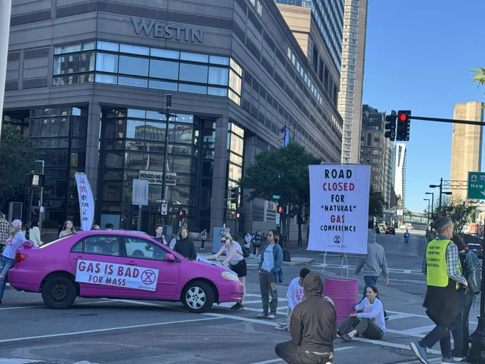 A pink car emblazoned with the phrase "GAS IS BAD FOR MASS" sits in the intersection at Copley Square. One activist is attached to the car while others have locked themselves to large pink oil barrels.   @MiriamWasser @shankman @davabel @boston25 @WCVB @NBC10Boston @wbz @7news @chronicle5 @deskon7 @wbznewsradio @WGBH @WBUR @ExtinctionR @SRTurtleIsland @ScientistRebel1 @350Mass @MothersOutFront @sunrisemvmt @ClimateDefiance