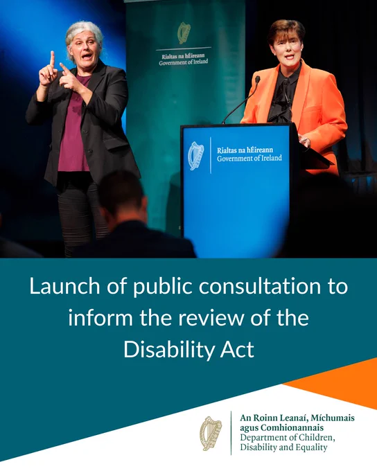 Minister Norma Foley, wearing an orange blazer, speaks at a podium during the launch of a public consultation to inform the review of the Disability Act. A sign language interpreter stands beside the podium. Government of Ireland branding and the Department of Children, Disability and Equality logo are displayed in the background and on the event graphic.