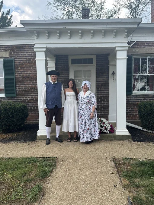 Lu Coon posing with a man and woman dressed in colonial outfits