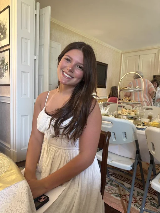 Lu Coon smiling at camera during tea party