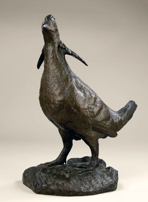 A bronze statue of a standing prairie chicken with neck feathers extended against a tan backdrop