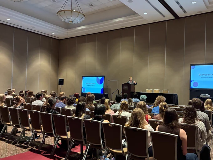 Cindy Brown, Employer Development Manager from Grand Valley State University, stands at podium speaking to audience at the "Classroom to Career Workshop: Preparing Environmental Professionals."