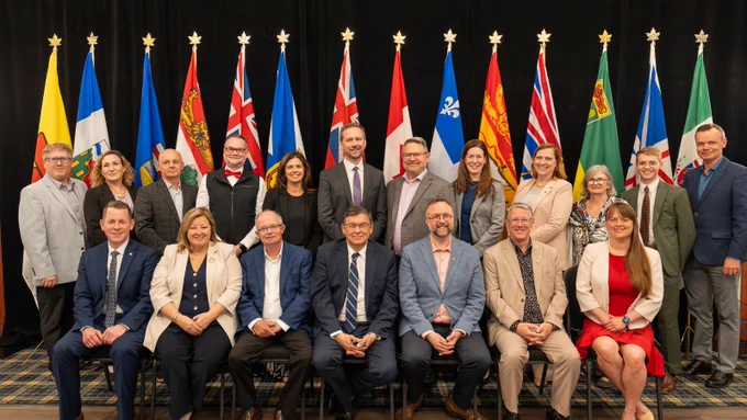 Federal, provincial and territorial ministers, including Minister Belanger, pose for a group photo during a rural development meeting in Prince Edward Island.