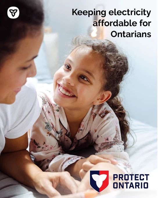 Young girl smiling at mother holding a bill for electricity