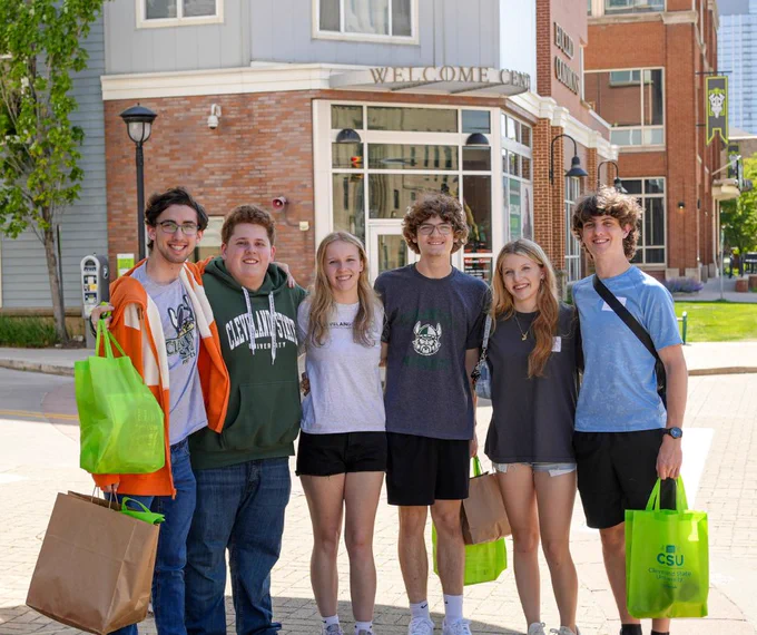 A group of six new CSU students posing together in front of Euclid Commons