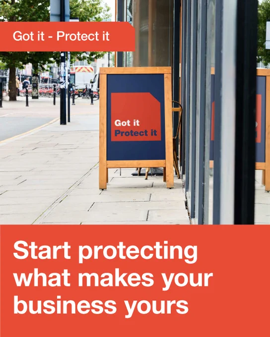 Wooden sandwich board  with bold text urging business owners to start protecting what makes their business unique.
