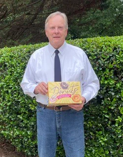 SBA's Jeff Patterson holds box of doughnuts in celebration of National Doughnut Day
