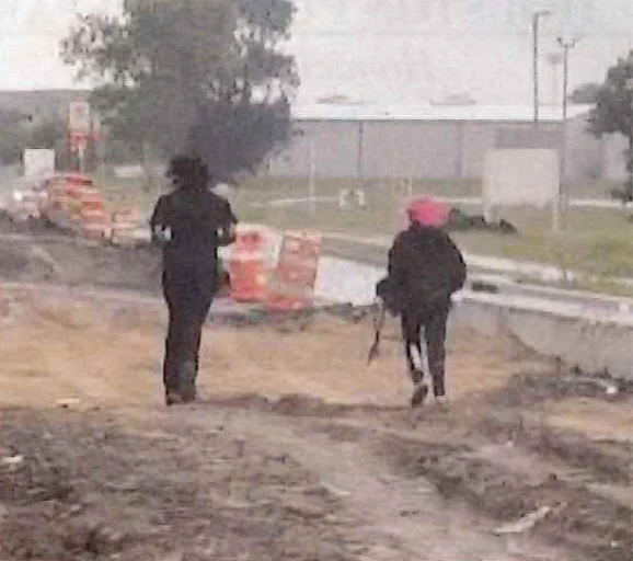 Surveillance photo of two individuals fleeing the scene