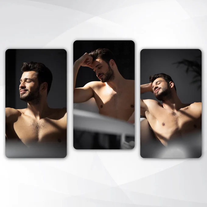 A high-contrast portrait: a man with dark hair and a beard leans back in a white bathtub, dramatic sunlight and shadows sculpting his physique. The intersection of light and form creates a timeless silhouette.