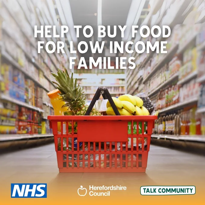 A shopping basket full of food in a supermarket aisle, with text promoting help for low-income families.