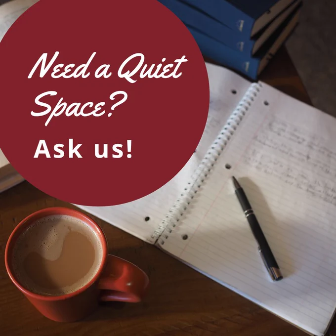 A notebook and pen sit beside a stack of books and a steaming cup of coffee. The text over the image reads, "Need a quiet space? Ask us!"