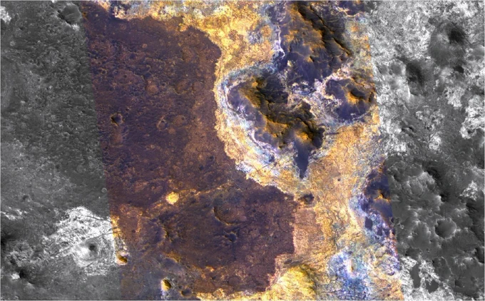 Image taken of the surface of Mars from the Mars Reconnaissance Orbiter showing two different paleo-units running up against each other. The flat unit is lightly cratered. The border is curved and tracks around an outcrop in the middle of the picture. The terrain on the right is rougher. The border may be the edge of an ancient ocean.