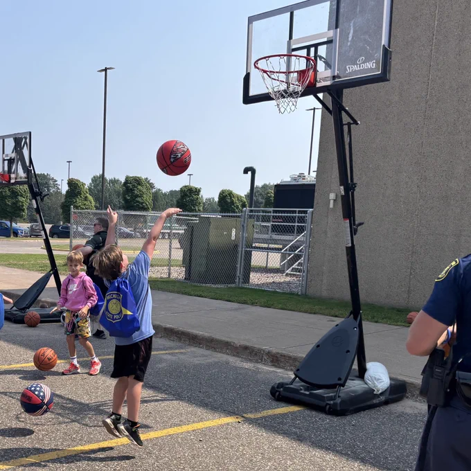 Kid shooting basketball with troopers