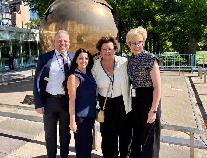 Image of Inclusion Canada's delegation appearing outside of the UN General Assembly HQ in New York. Left - right Kurt Goddard, Tara Levandier, President Moira Wilson, Krista Carr, CEO. 