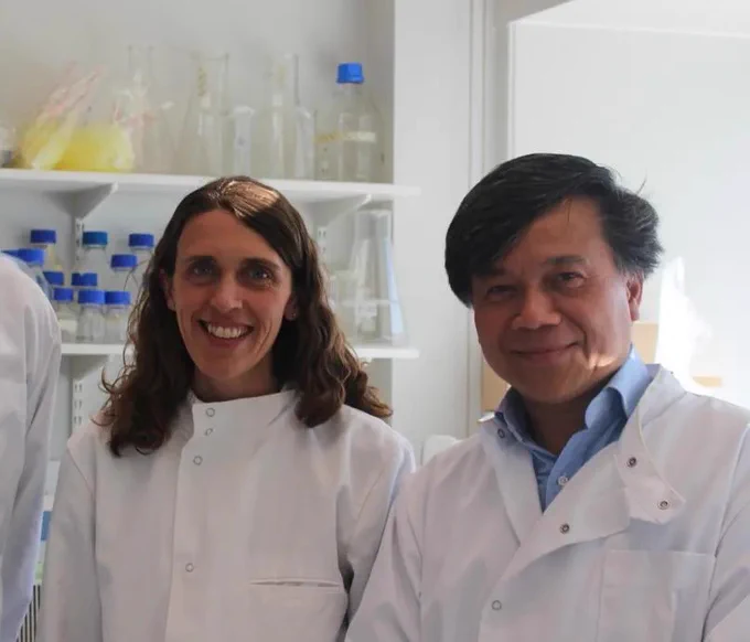 Prof ye oo and Dr Claire Palles standing in a science lab wearing lab coats