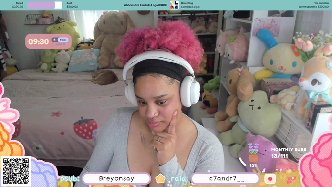 a screenshot of ChiChi on his chatting overlay, which has a pink floral themed border, a camera source of ChiChi on the middle, and the most recent subscriber and raider along the bottom border. ChiChi's camera source shows him, a light-skinned, feminine Black person with pink curly hair in a high puff. there are many various plushies visible in the background.