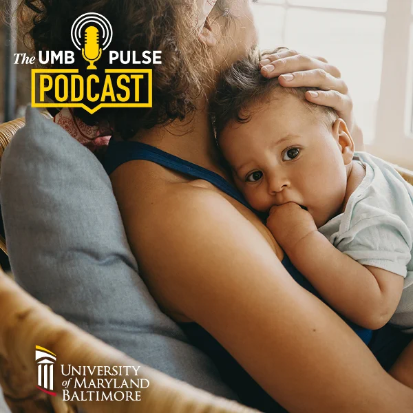 Mother tenderly holding her child close while sitting on a couch near a bright window, promoting The UMB Pulse Podcast by University of Maryland Baltimore.
