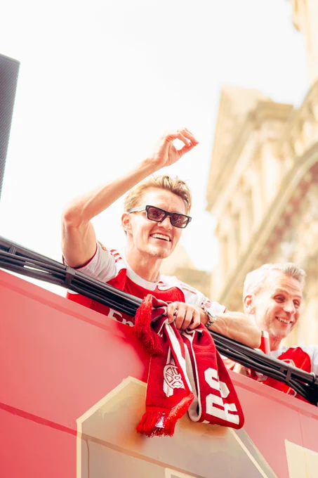 Martin Odegaard celebrates on the bus at the parade.