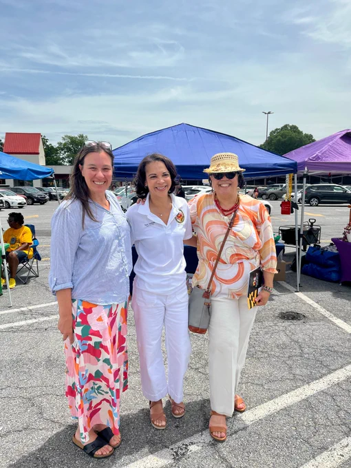 Secretaries Betsy Fox Tolentino and DHS Acting Secretary Stacy L. Rodgers, along with a government leader, pose together, smiling on District Heights Day.