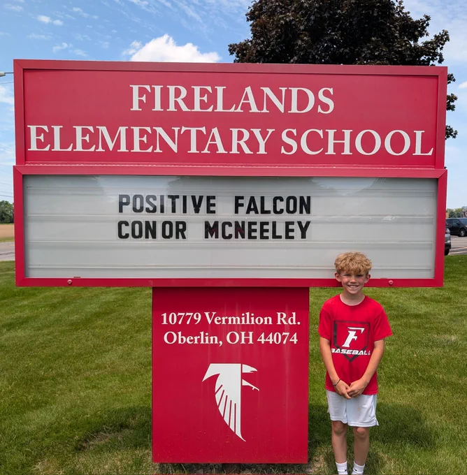 Student in front of sign 