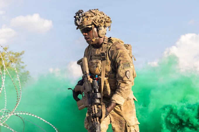 A U.S. Soldier assigned to the 3rd Mobile Brigade, 25th Infantry Division, advances toward an objective after combat engineers breached concertina wire during platoon live fire training as part of Salaknib 2026 at Fort Magsaysay, Nueva Ecija, Philippines, May 26, 2026.