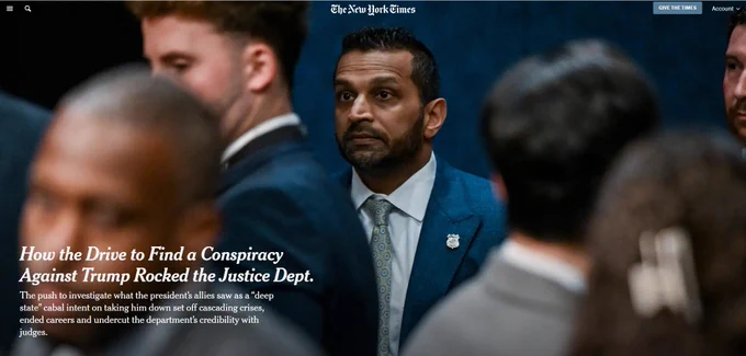 FBI Director Kash Patel stands in a crowd of men in suits, looking off to the side with a flat expression, an FBI badge pinned to the lapel of his blue jacket. Foreground figures are blurred. Overlaid text reads: "How the Drive to Find a Conspiracy Against Trump Rocked the Justice Dept."