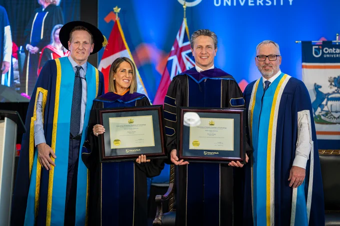 A photo of honorary degree recipients Mark Mulroney, Global Vice Chair, CIBC, and Vanessa Mulroney, co-founder, Power of Privé, posing on stage at Ontario Tech's 2026 Spring Convocation ceremony with Ontario Tech Chancellor Mitch Frazer and Ontario Tech President Steven Murphy.